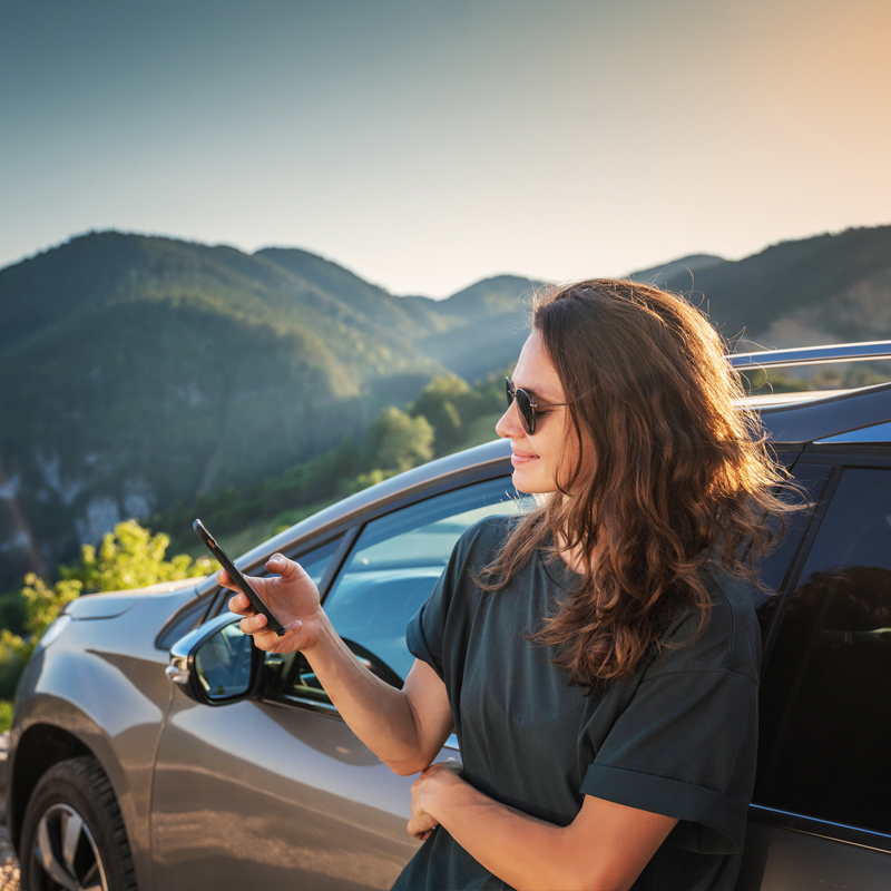 Woman checking insurance covarage on side of road